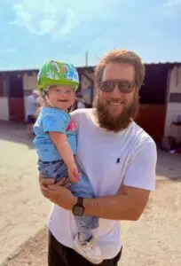 Maisy and Dadda smiling together during their Down Syndrome parenting journey
