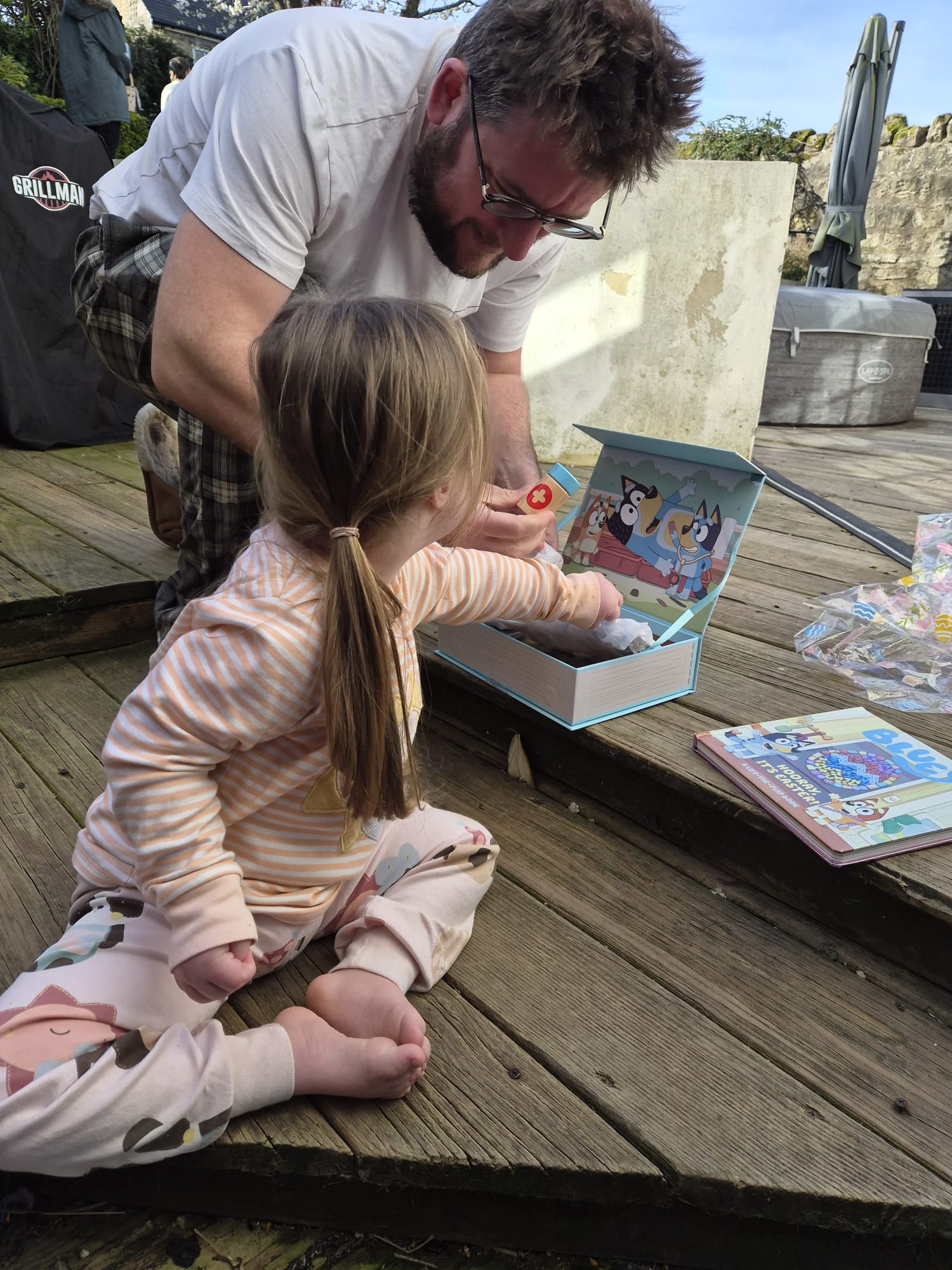down syndrome fine motor skills being shown as toddler explores toys in a box
